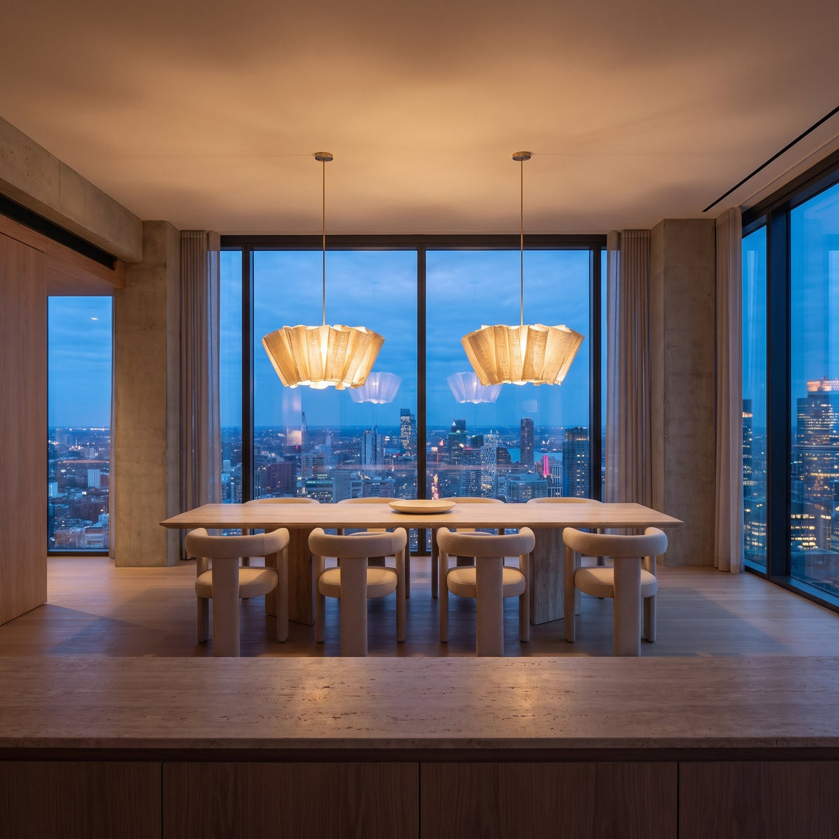 Two Pleated Wave Linen LED Pendant Lights, Ø60 cm, above a travertine dining table in a city penthouse