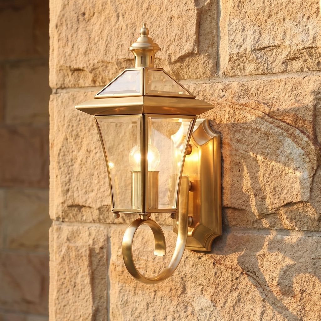 Polished Brass Coastal Outdoor Wall Lantern, close view at 45 degrees on a stone wall