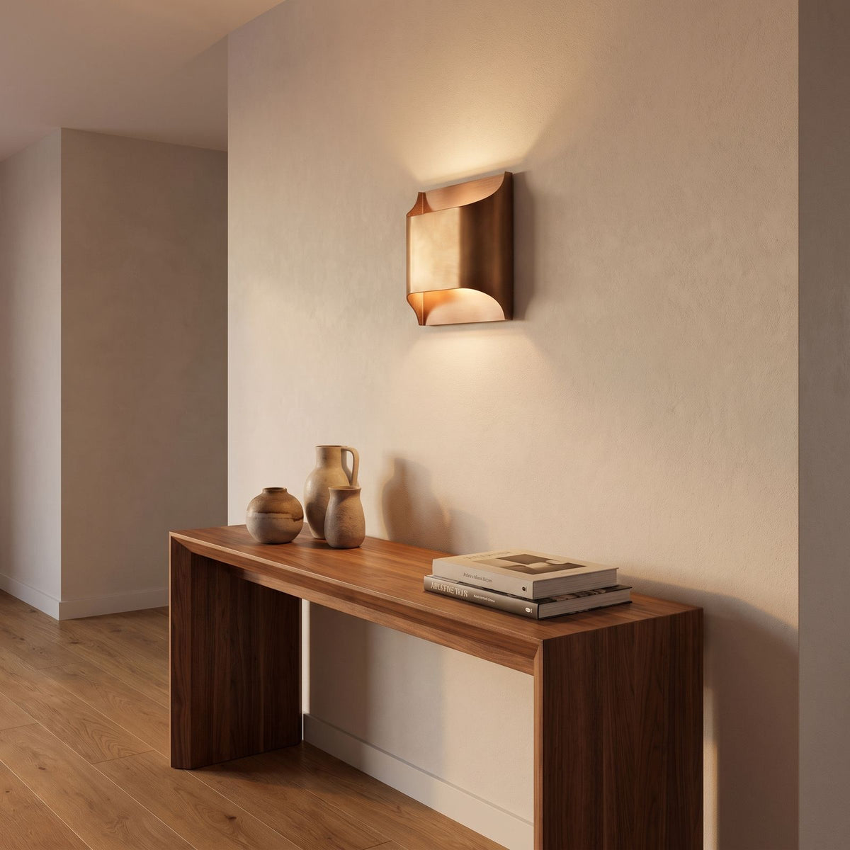 Polished Copper Double LED Wall Light in a hallway above a timber console