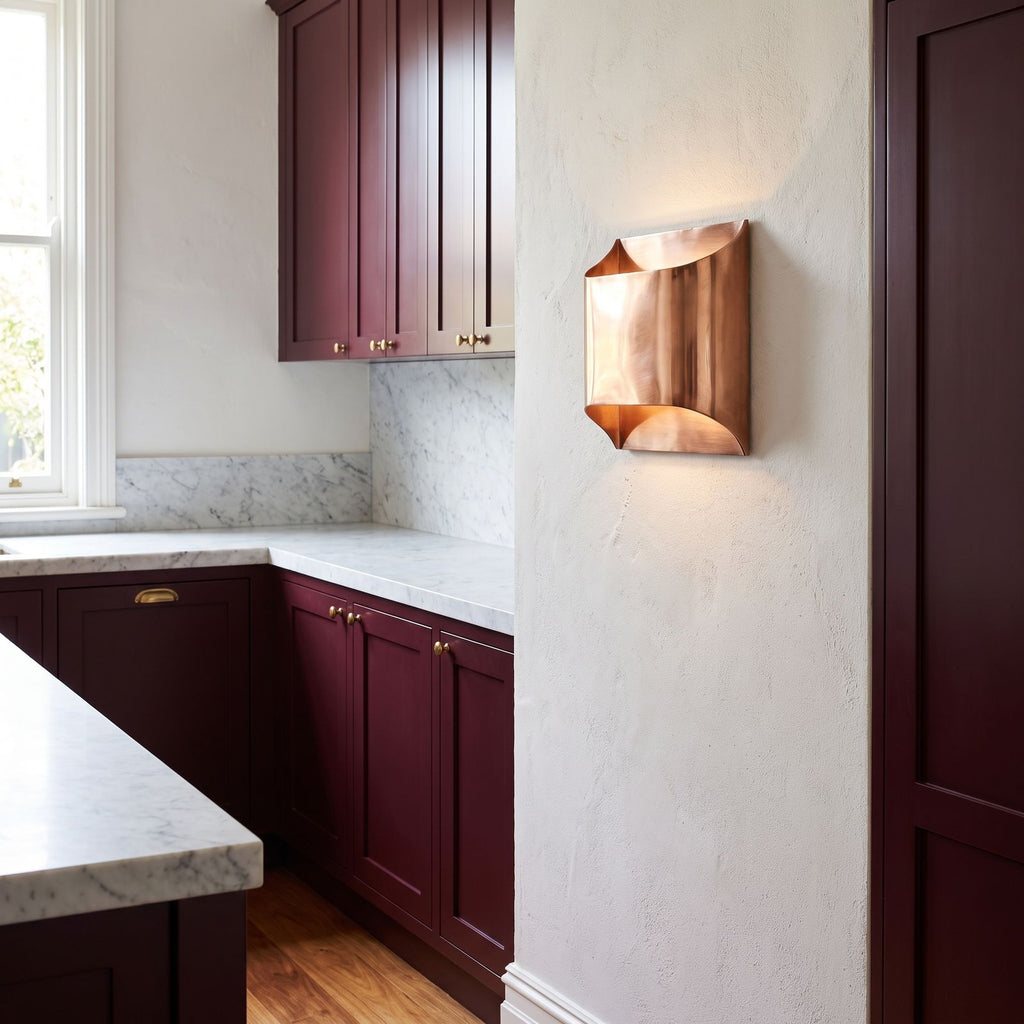 Polished Copper Double LED Wall Light on a kitchen wall