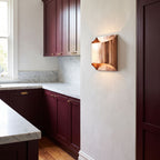 Polished Copper Double LED Wall Light on a kitchen wall