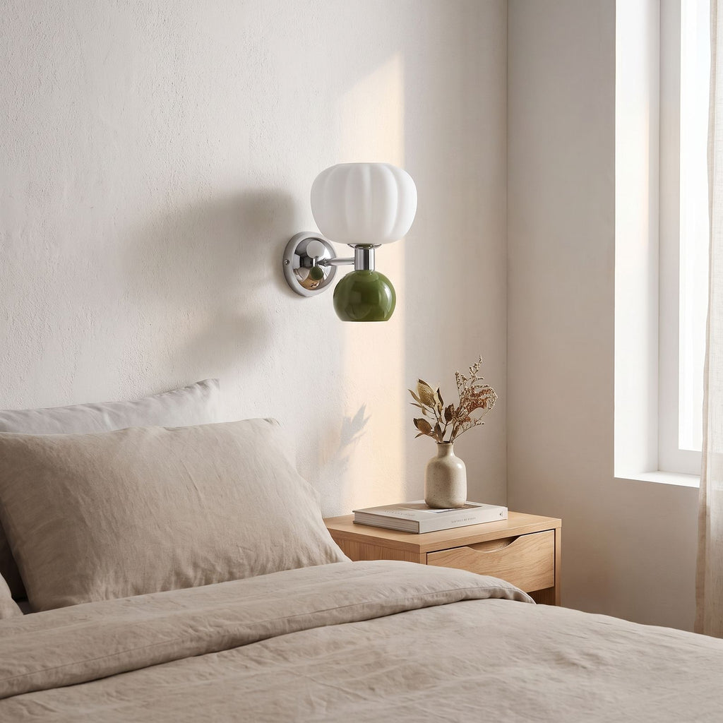 Pumpkin Shade Chrome Wall Sconce on a bedroom wall beside the bed