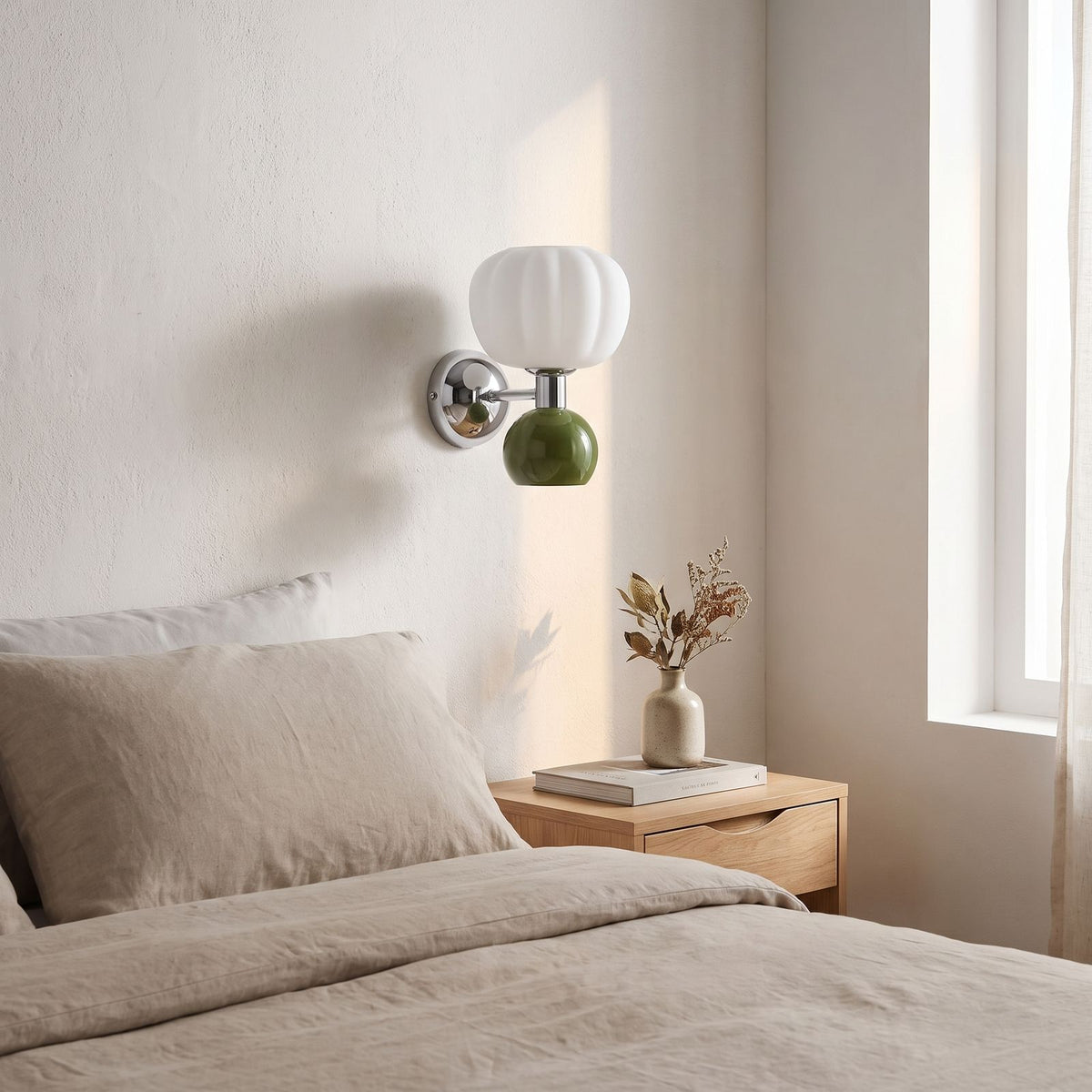 Pumpkin Shade Chrome Wall Sconce on a bedroom wall beside the bed