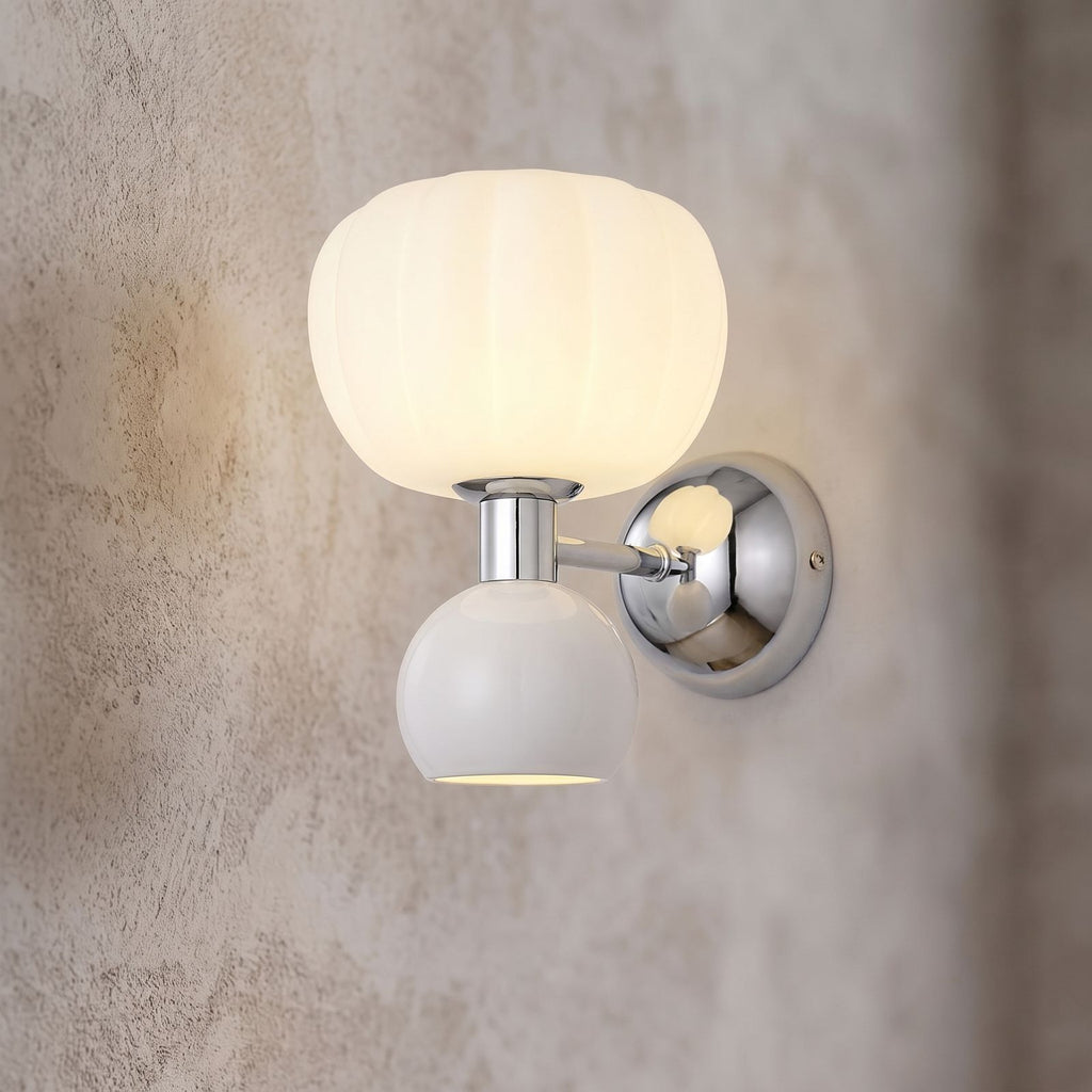 Pumpkin Shade Chrome Wall Sconce, close view at 45 degrees on a plaster wall