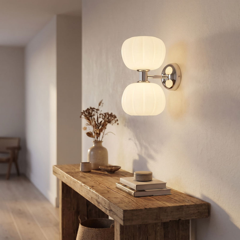 Pumpkin Shade Chrome Wall Sconce in a hallway above a timber console