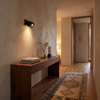 Recessed Pop-Out Bedside Reading Wall Light in a hallway above a timber console