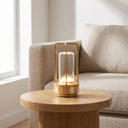 Rechargeable cylinder lantern table lamp on a side table beside a sofa in daylight