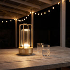 Rechargeable cylinder lantern table lamp on a patio table at night
