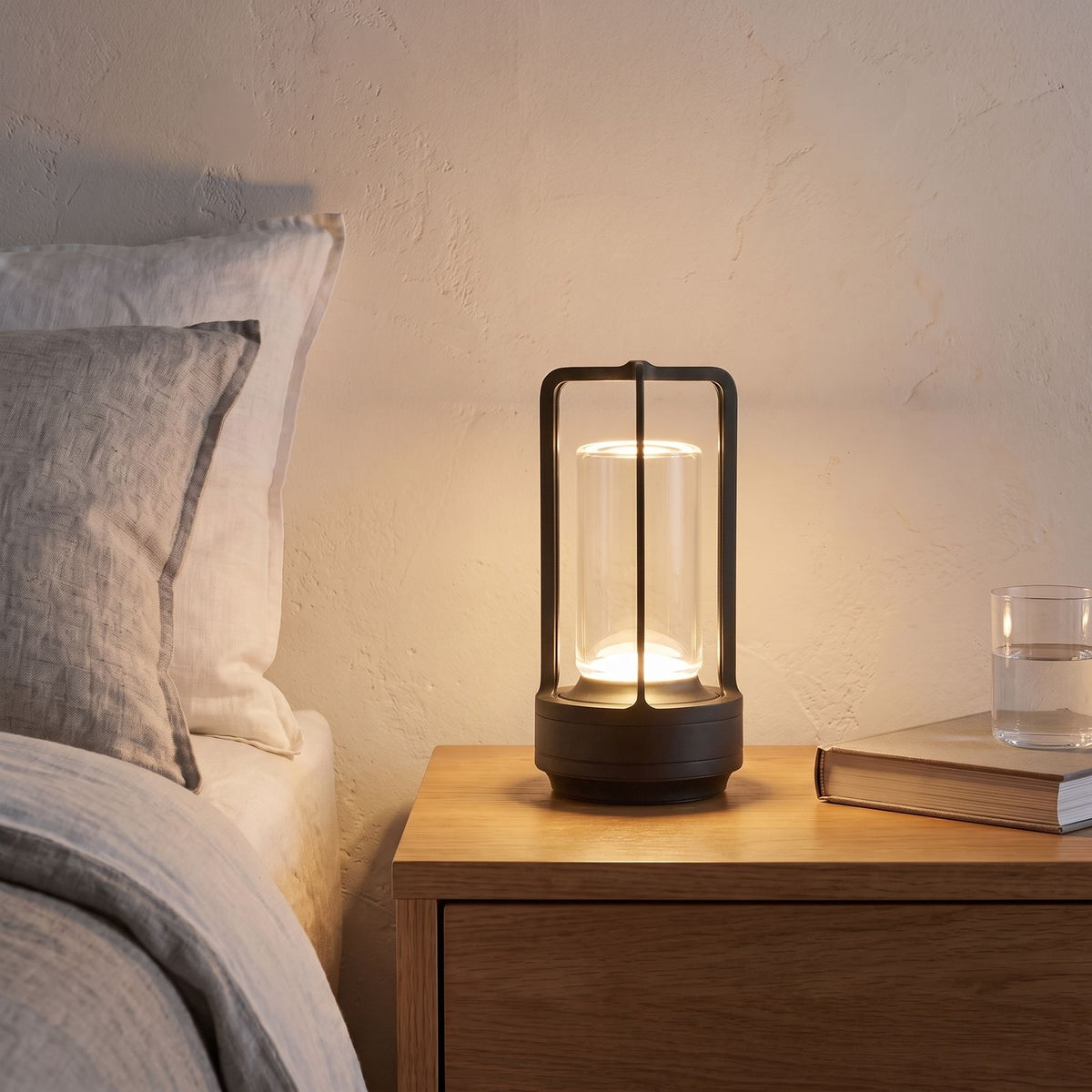 Rechargeable Clear Cylinder Lantern Table Lamp in black on a bedside table