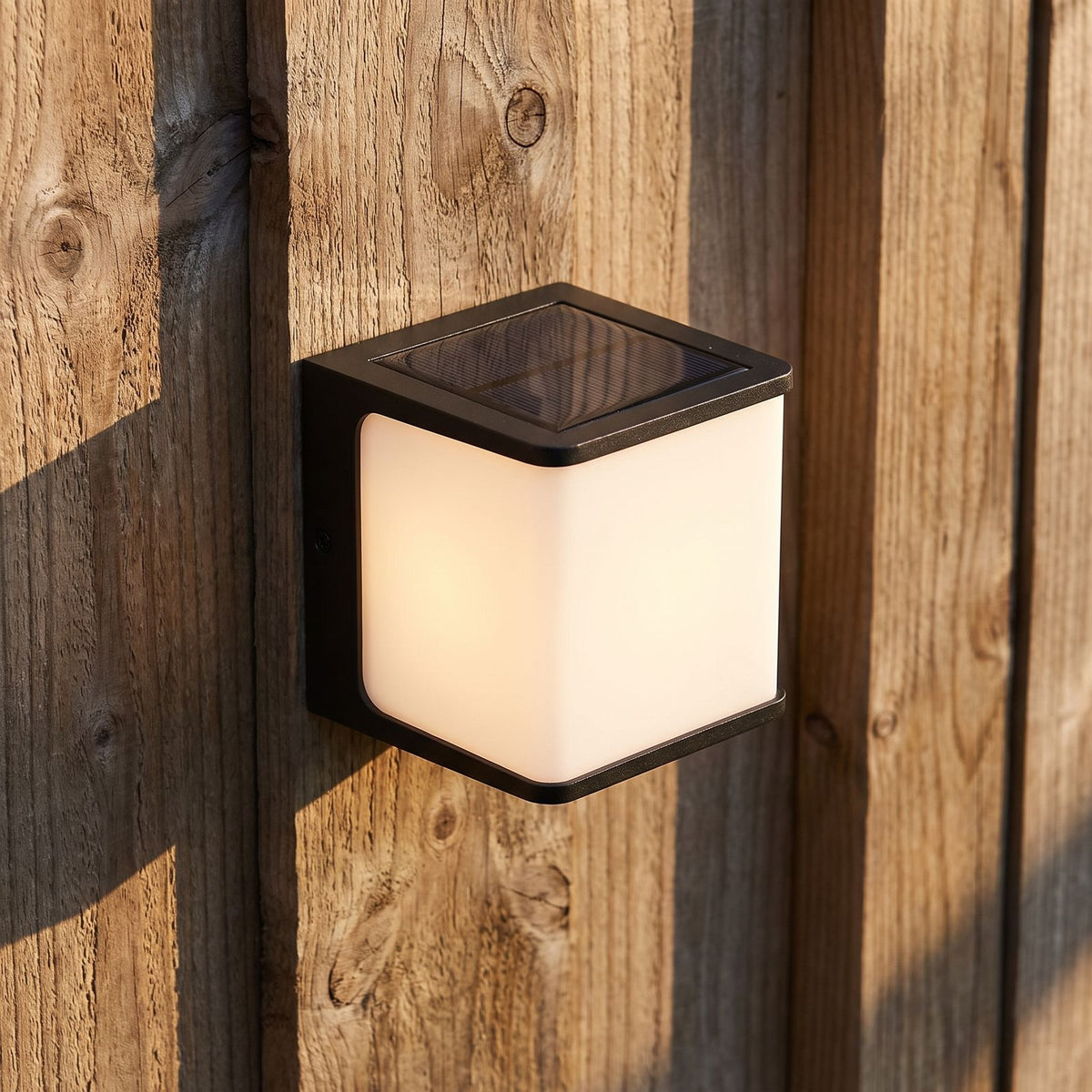 Rectangular Acrylic Solar Outdoor Wall Light, close view at 45 degrees on a stone wall