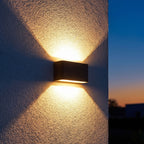 Rectangular Acrylic Up Down Outdoor Wall Light on a porch wall at dusk