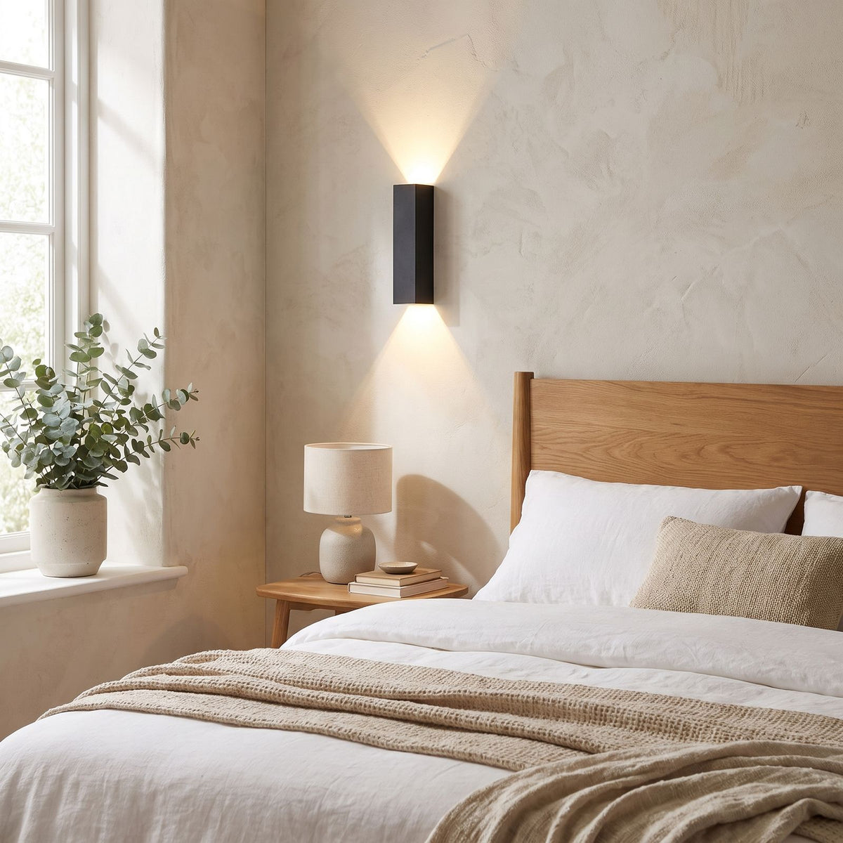 Rectangular Aluminium and Glass Up-Down Wall Light on a bedroom wall beside the bed