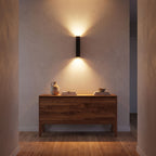 Rectangular Aluminium and Glass Up-Down Wall Light in a hallway above a timber console