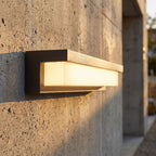 Rectangular Metal and Acrylic Outdoor Wall Light, close view at 45 degrees on a stone wall
