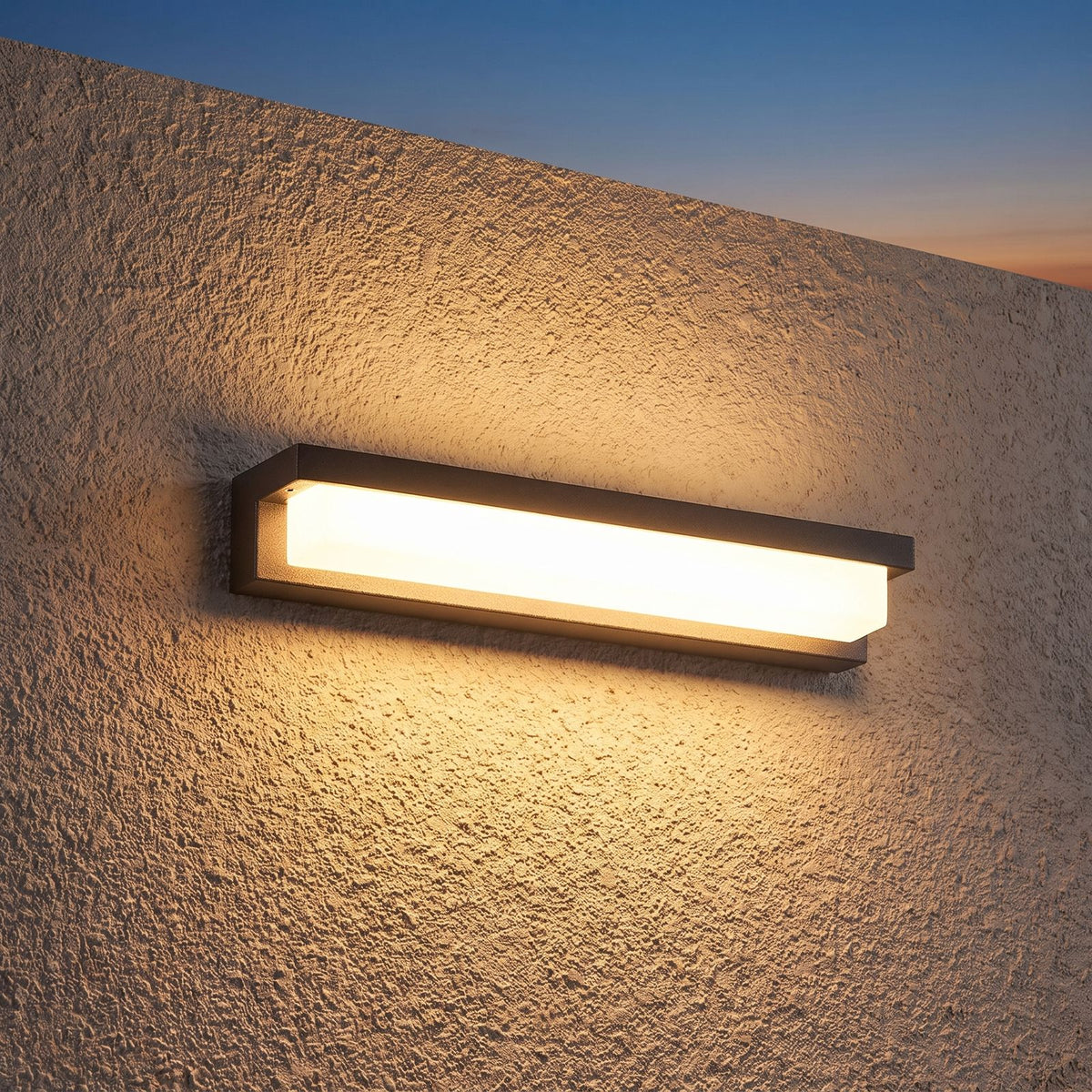 Rectangular Metal and Acrylic Outdoor Wall Light on a porch wall at dusk