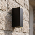 Rectangular Metal Up Down Outdoor Wall Light, close view at 45 degrees on a stone wall
