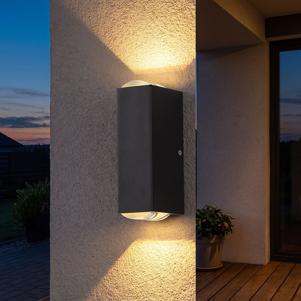 Rectangular Metal Up Down Outdoor Wall Light on a porch wall at dusk