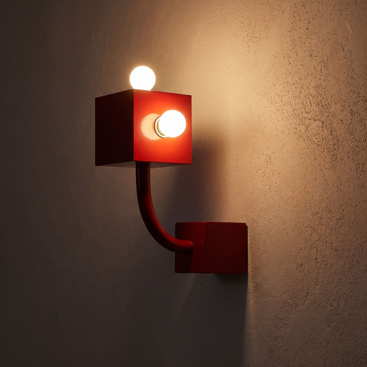 Red Iron Cube Wall Light glowing on a plaster wall at night