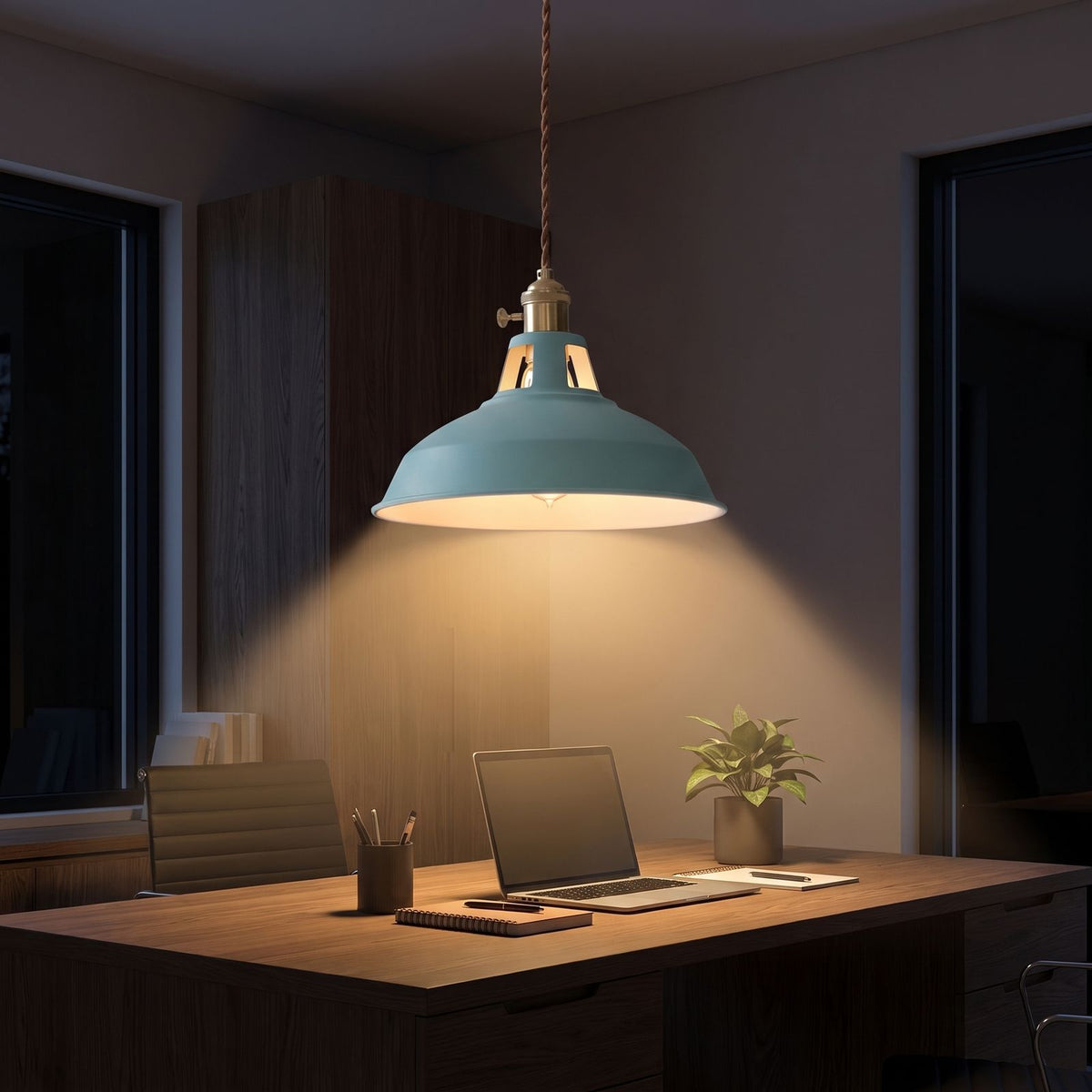 Retro barn shade aluminium pendant light over a home office desk at night