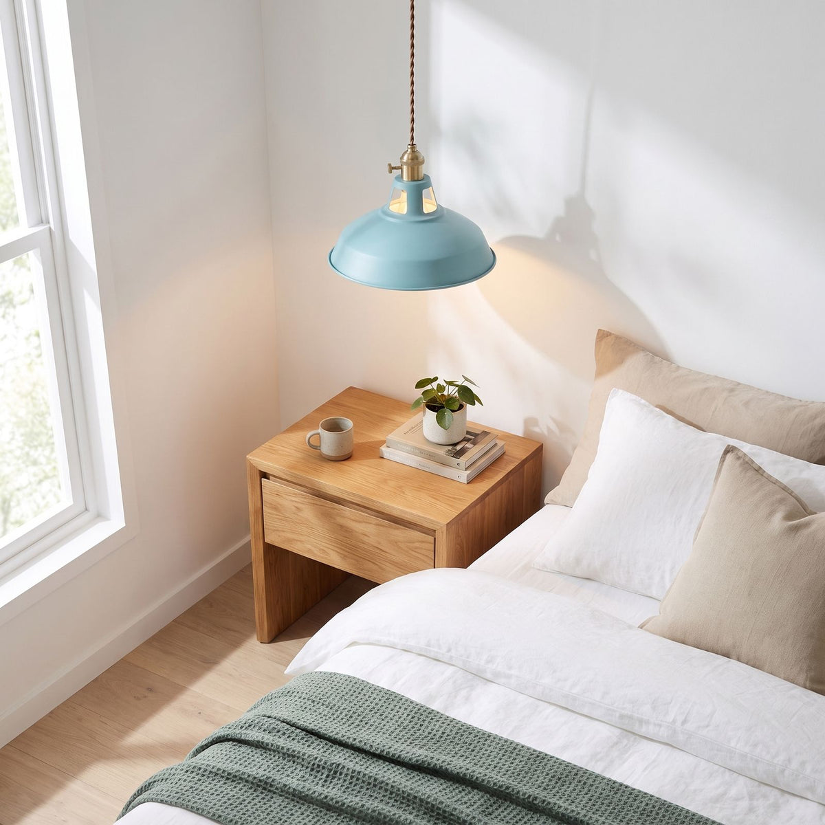 Retro barn shade aluminium pendant light beside a bed in daylight