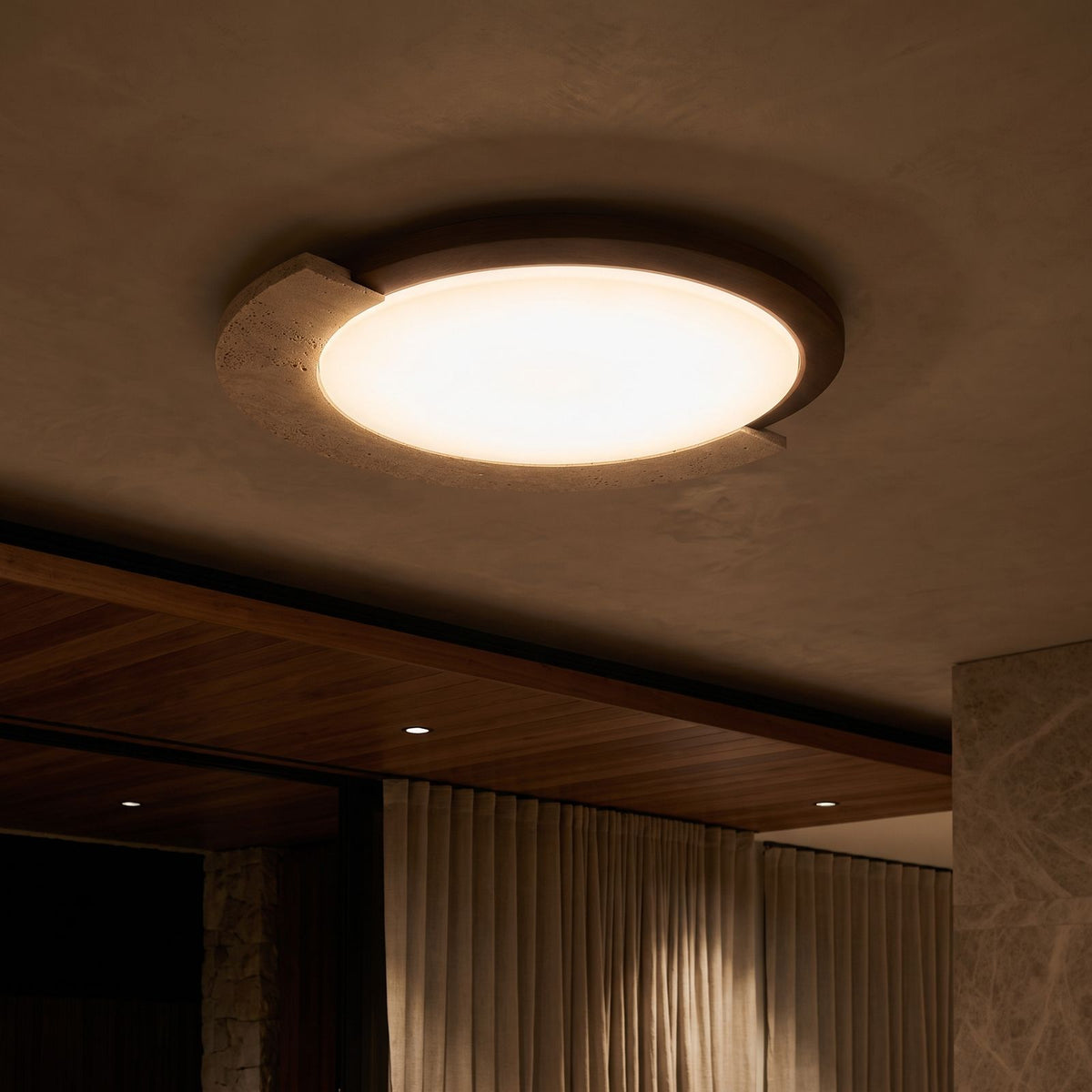 Retro Geometric Stone and Wood Ceiling Light glowing on a ceiling at night