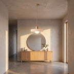 Ribbed disc and matte glass pendant light in a wide entry hall view