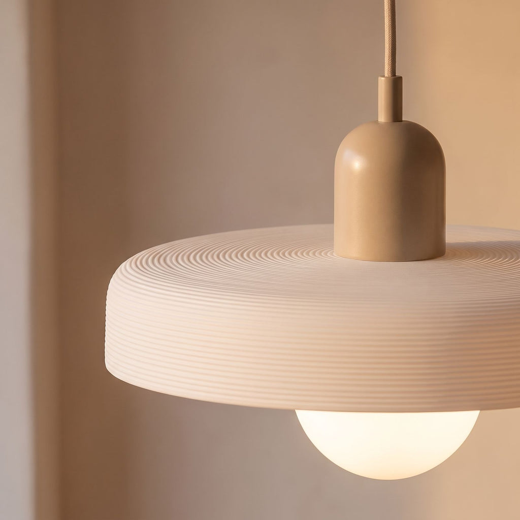 Close-up of the ribbed disc rim, beige cap and frosted glass