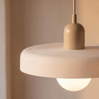 Close-up of the ribbed disc rim, beige cap and frosted glass