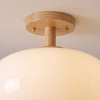 Close-up of the milky white glass shade and timber canopy