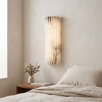 Ribbed Alabaster Column LED Wall Light on a bedroom wall beside the bed