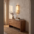Ribbed Alabaster Column LED Wall Light in a hallway above a timber console