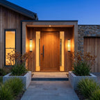 A pair of Ribbed Glass Cylinder Outdoor Wall Lights either side of a timber front door