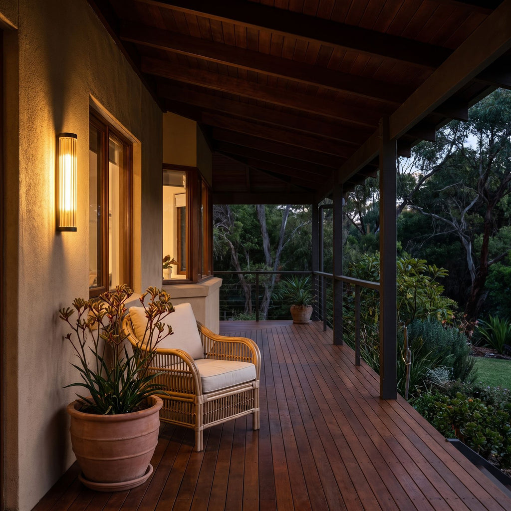 Ribbed Glass Cylinder Outdoor Wall Light on a timber veranda wall at dusk