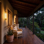 Ribbed Glass Cylinder Outdoor Wall Light on a timber veranda wall at dusk