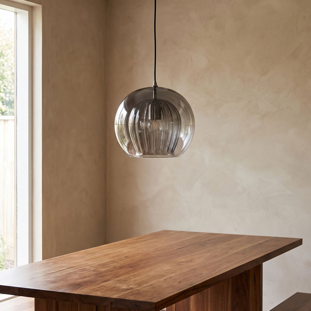 Ribbed Glass Globe Pendant Light above a timber dining table