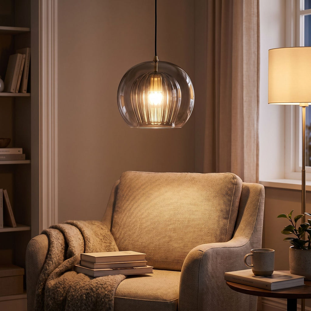Ribbed Glass Globe Pendant Light above a reading armchair