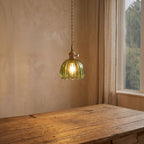 Ribbed Tulip Glass Mini Pendant Light above a dining table