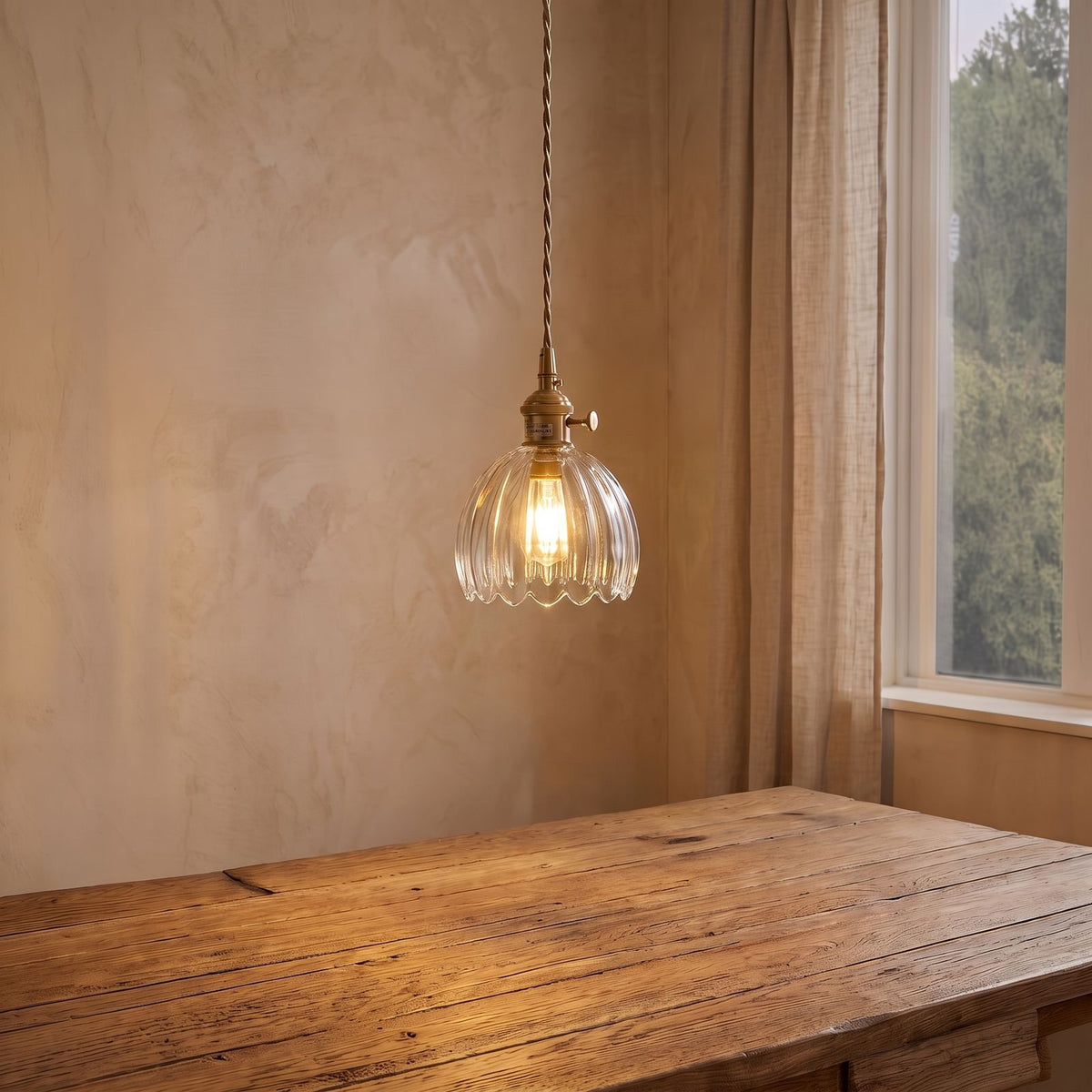 Ribbed Tulip Glass Mini Pendant Light in clear glass above a dining table