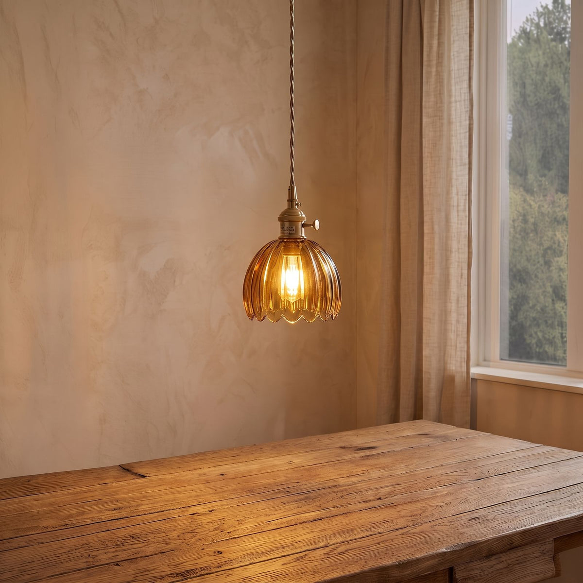 Ribbed Tulip Glass Mini Pendant Light in amber glass above a dining table