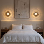 A pair of Rippled Smoked Glass Disc Wall Lights either side of a bedhead