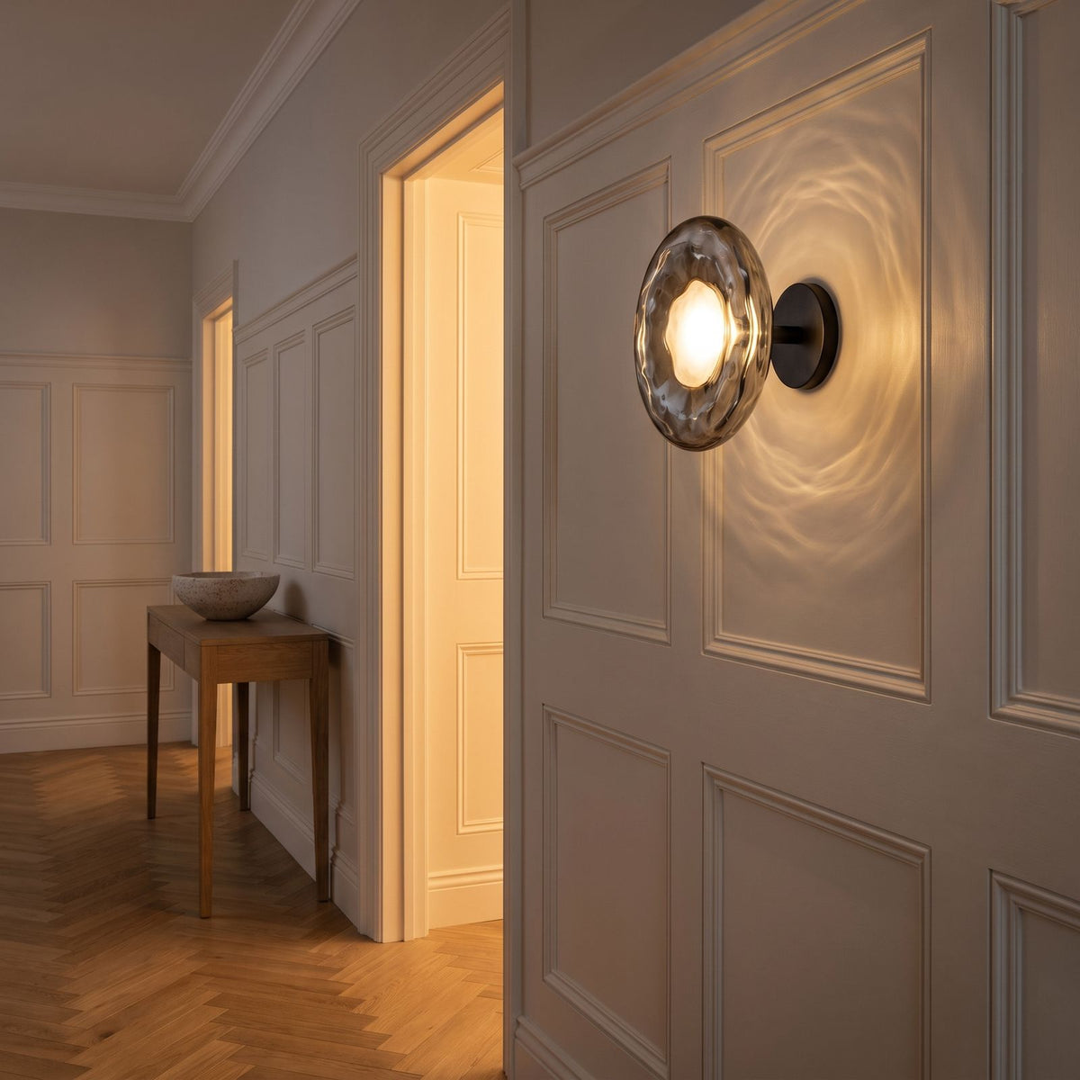 Rippled Smoked Glass Disc Wall Light in a panelled hallway
