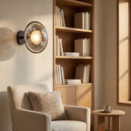 Rippled Smoked Glass Disc Wall Light beside a reading corner