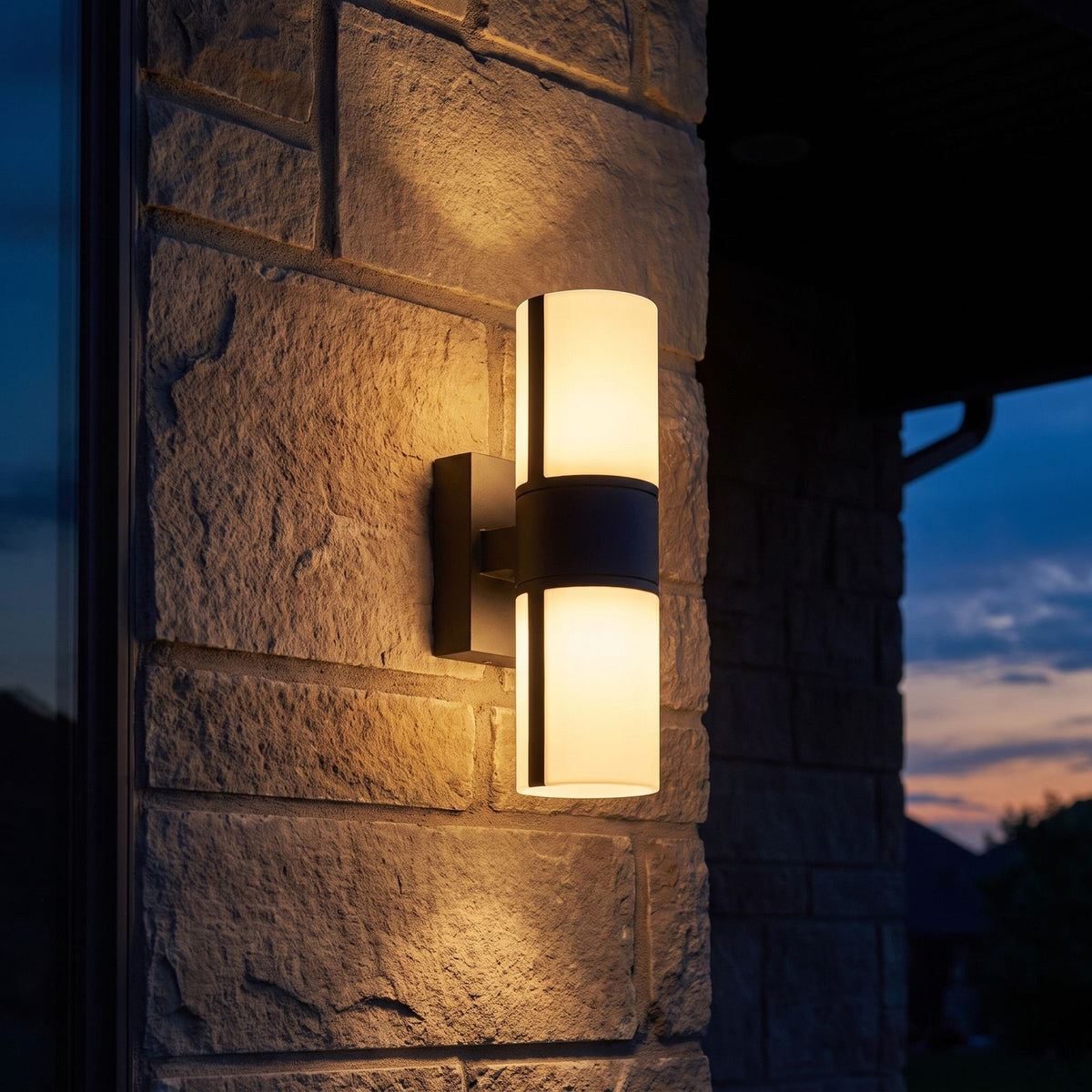 Rotatable Metal Band Acrylic Cylinder LED Outdoor Wall Light on a porch wall at dusk