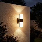 Rotatable Metal Band Acrylic Cylinder LED Outdoor Wall Light glowing on a garden wall at night