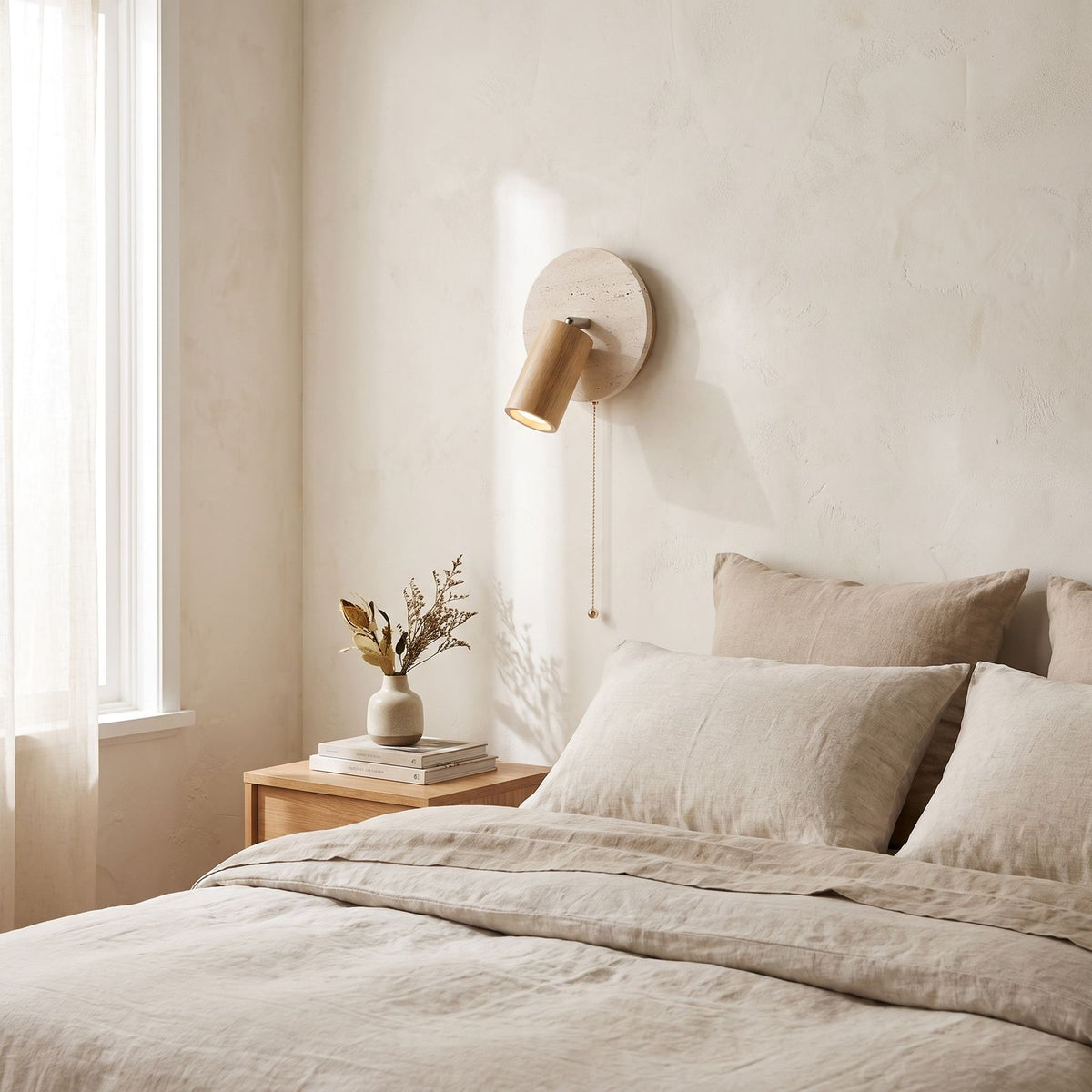 Rotatable Travertine Spotlight Wall Light on a bedroom wall beside the bed