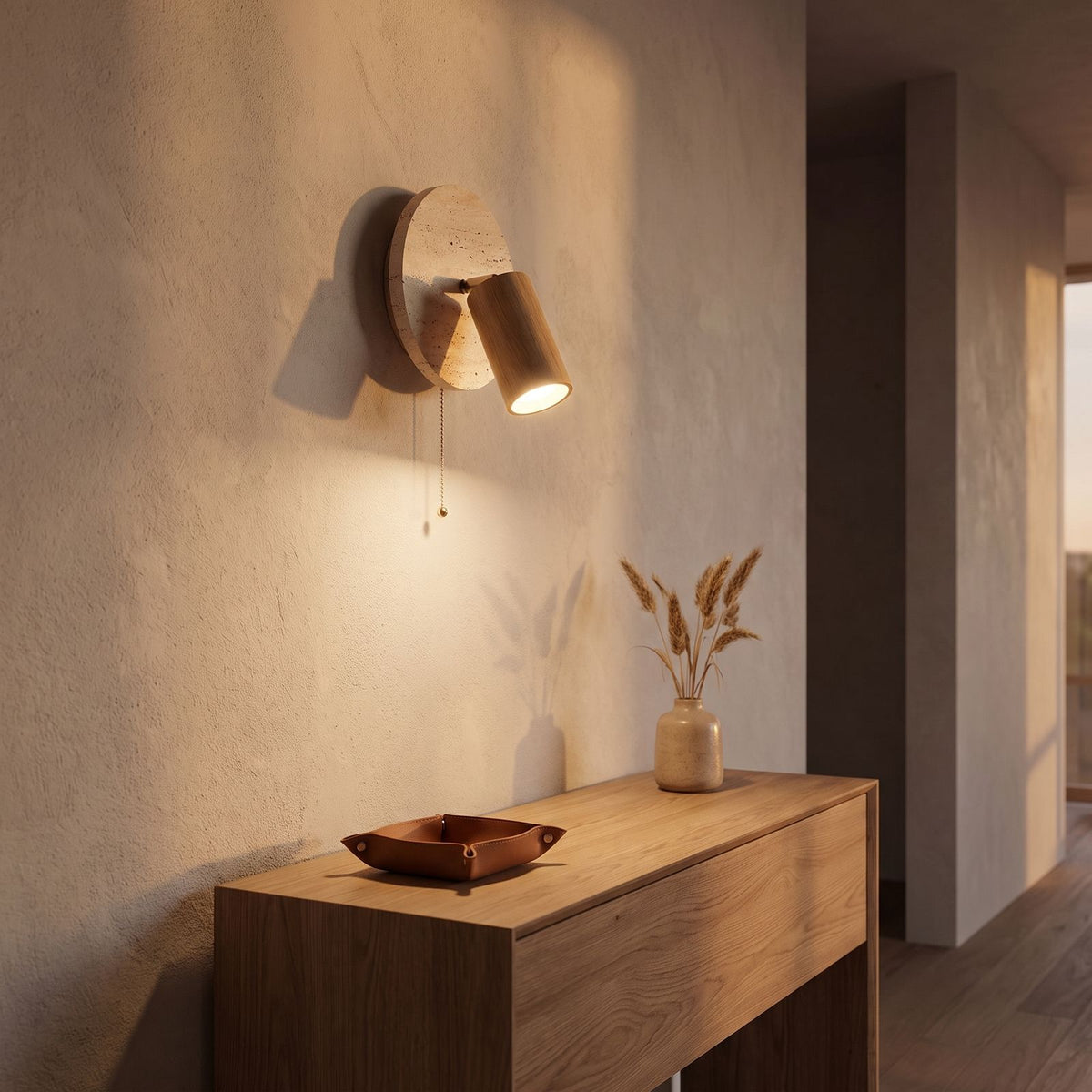 Rotatable Travertine Spotlight Wall Light in a hallway above a timber console