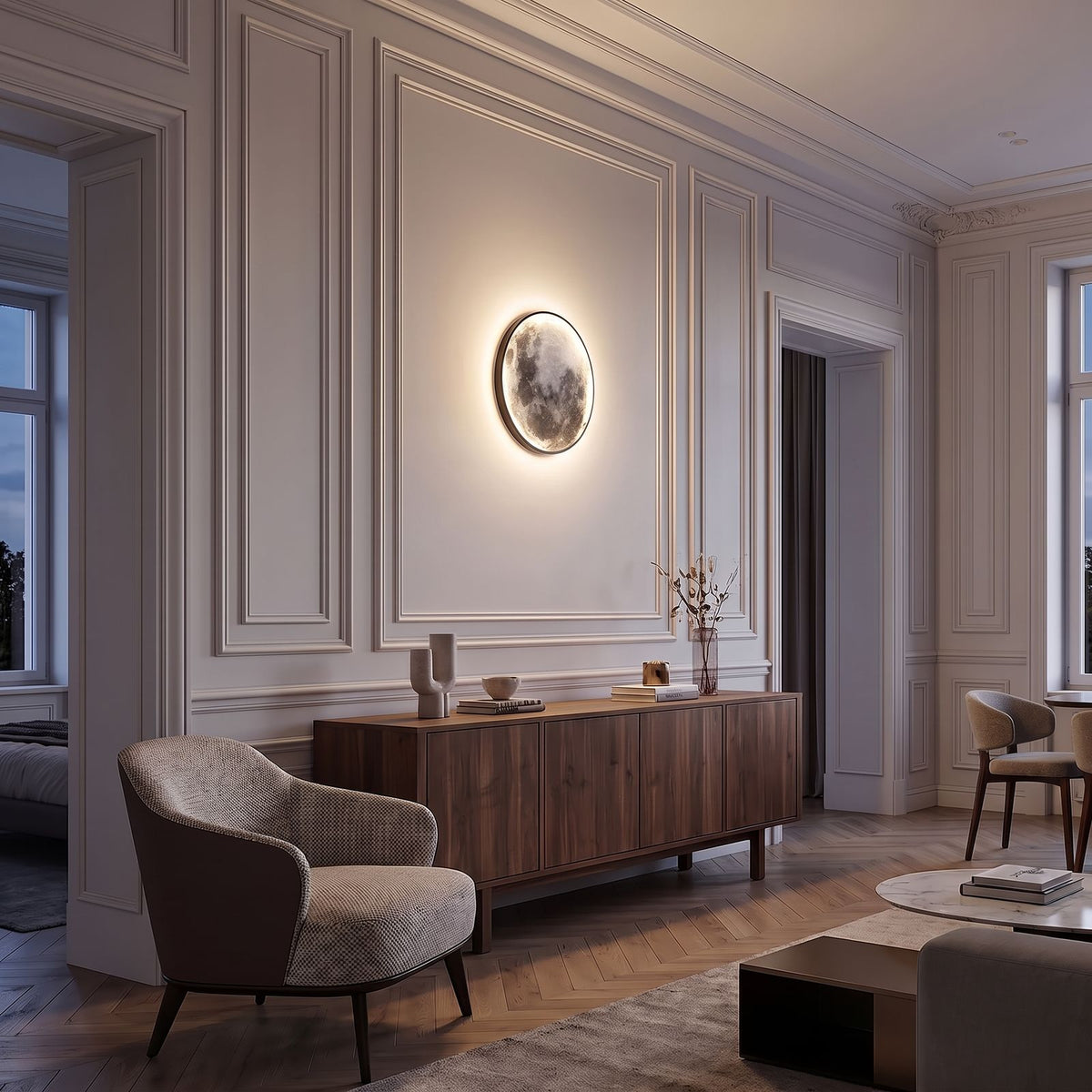 Round 3D Moon Black Frame LED Wall Light in warm white on a panelled living room wall above a walnut sideboard in the evening