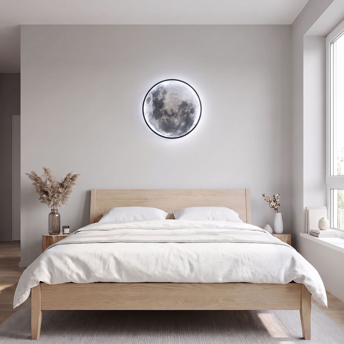Round 3D Moon Black Frame LED Wall Light in cool white above the bed in a Scandinavian bedroom in daylight