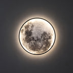 Round 3D Moon Black Frame LED Wall Light close view of the 3D moon face and the black metal ring, switched on