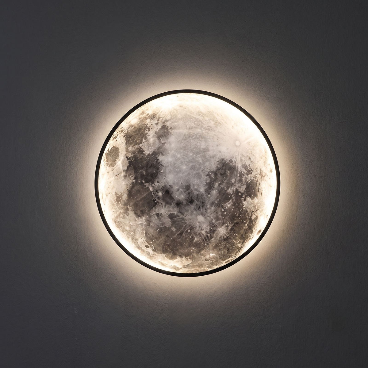 Round 3D Moon Black Frame LED Wall Light close view of the 3D moon face and the black metal ring, switched on